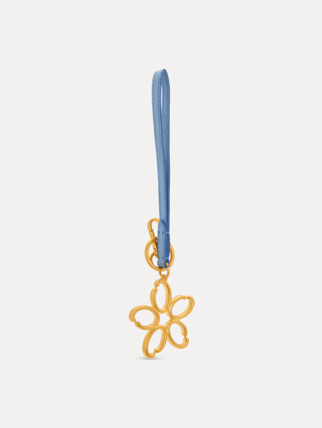 Gold O Flower Wristlet Key Chain with five open petals hangs from a blue leather loop strap, attached by a small gold ring and clasp. Side View.