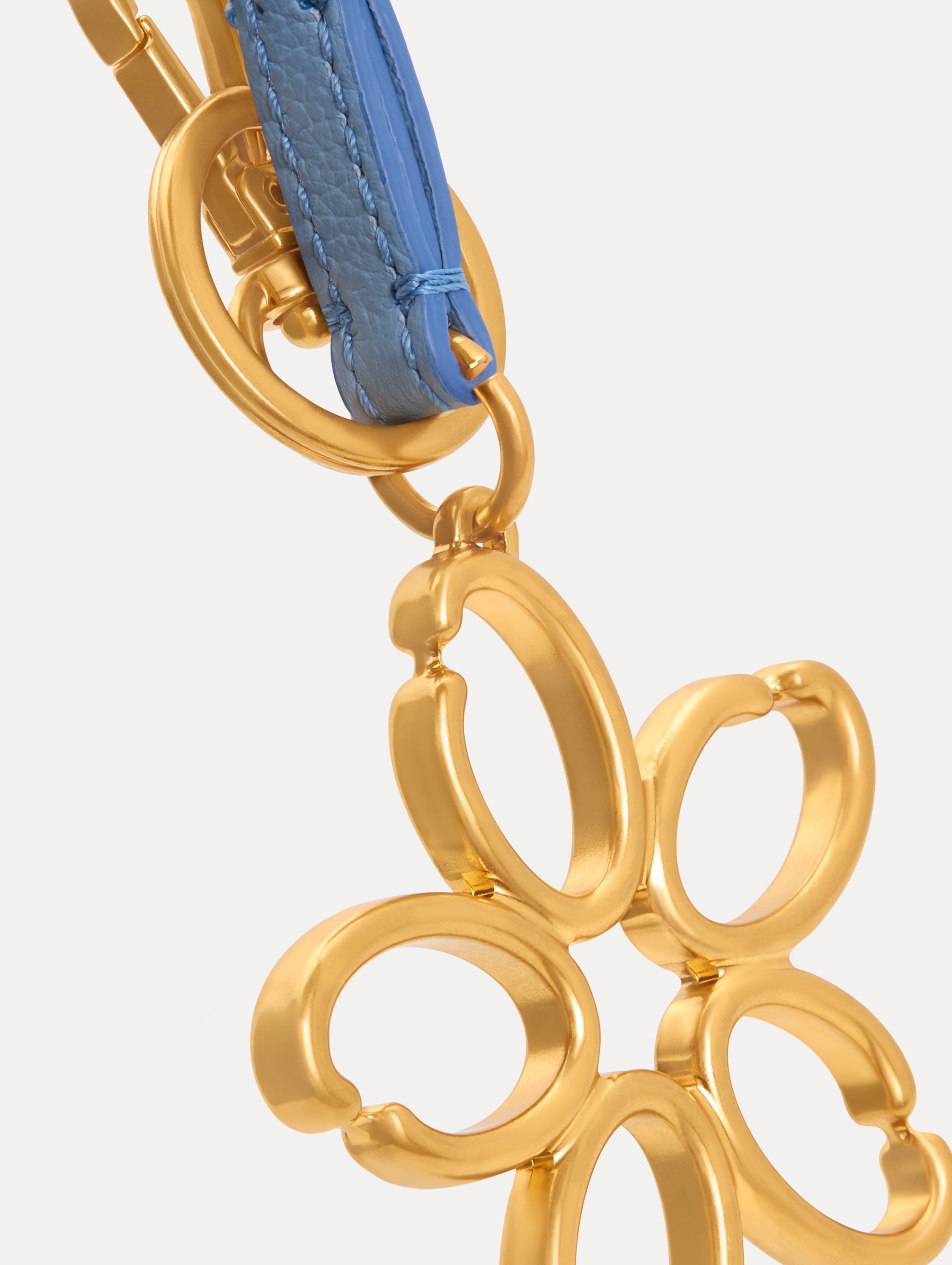 Gold O Flower Wristlet Key Chain with five open petals hangs from a blue leather loop strap, attached by a small gold ring and clasp. Zoom View.