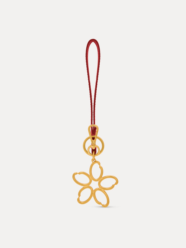 Gold O Flower Wristlet Key Chain with a five-petal open flower that hangs from a deep red leather loop strap, connected by a small gold ring and clasp. Back View. 