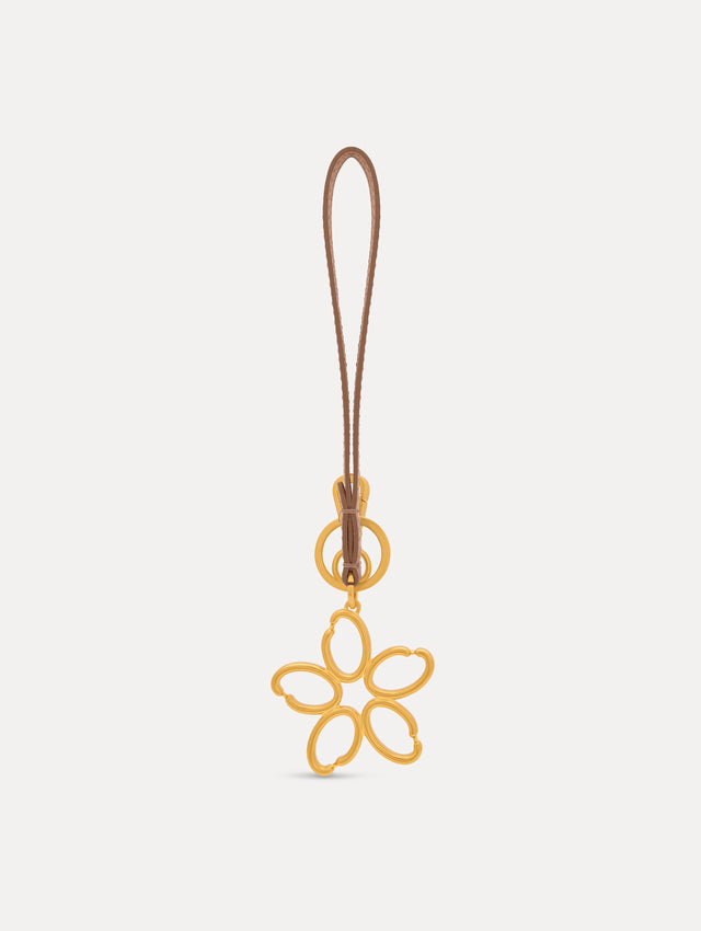 Gold O Flower Wristlet Key Chain with five open petals hangs from a sand leather loop strap, attached by a small gold ring and clasp. Front View.