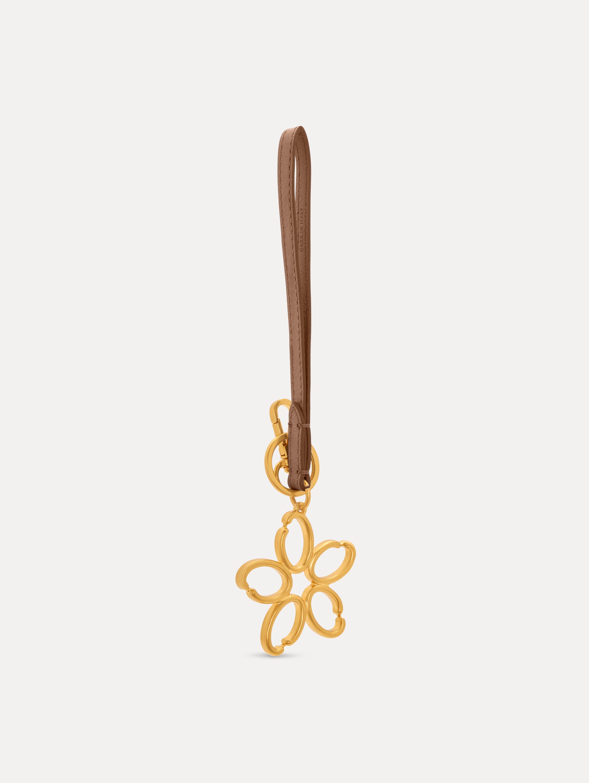 Gold O Flower Wristlet Key Chain with five open petals hangs from a sand leather loop strap, attached by a small gold ring and clasp. Side View.