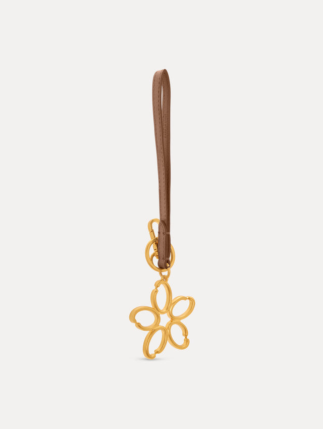 Gold O Flower Wristlet Key Chain with five open petals hangs from a sand leather loop strap, attached by a small gold ring and clasp. Side View.