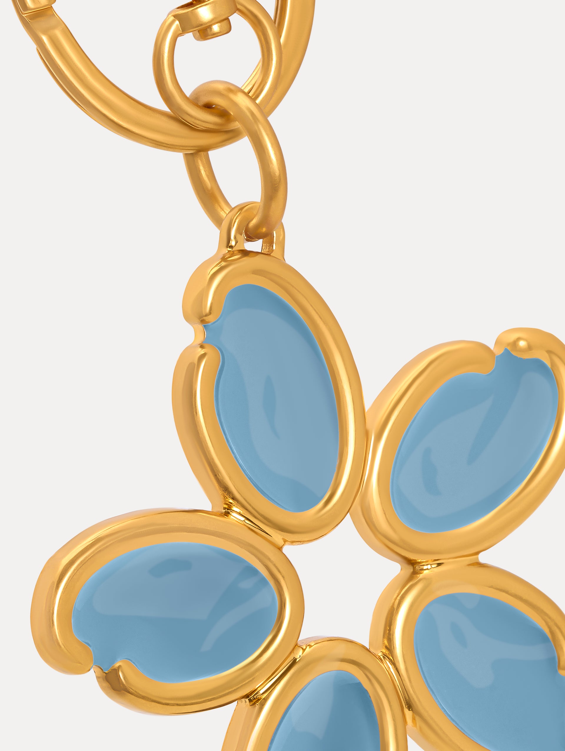 Gold Enamel O Flower Key Chain featuring a five-petal flower charm with smooth, light blue enamel inlays framed by rounded gold edges, attached to a circular clasp. Zoom View.