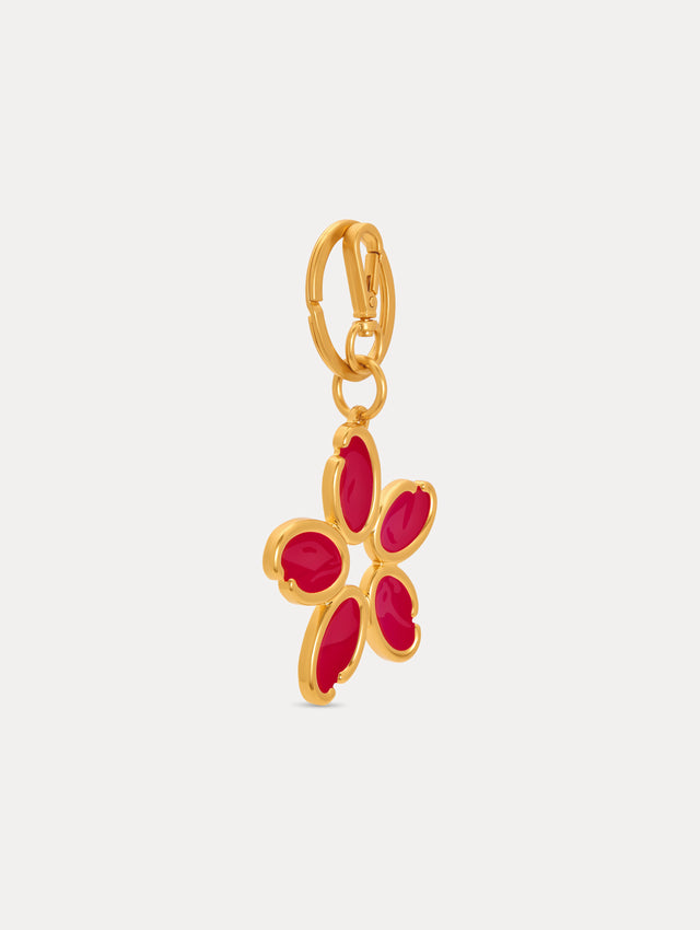 Gold Enamel O Flower Key Chain featuring a five-petal flower charm with smooth, red inlays framed by rounded gold edges, attached to a circular clasp. Side View.