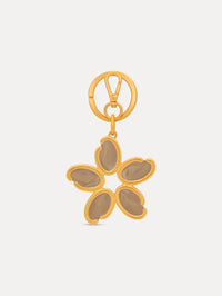 Gold Enamel O Flower Key Chain featuring a five-petal flower charm with smooth, taupe-colored inlays framed by rounded gold edges, attached to a circular clasp. Front View.