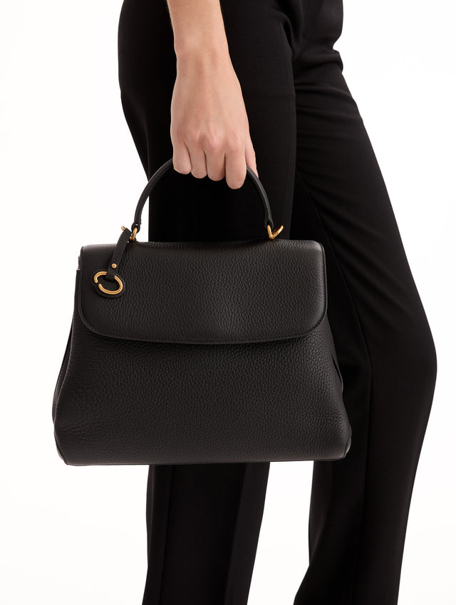 The Poppy Leather Handbag in Black with O logo Tag around the Top Handle, and Detachable Shoulder Strap.  Front View.