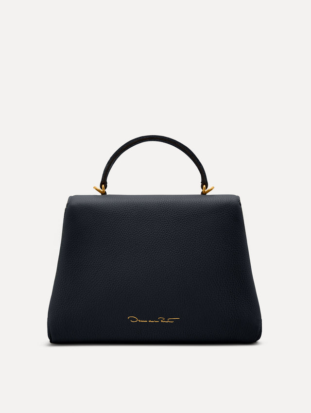 The Poppy leather bag in dark navy with O logo tag around the top handle. Back View