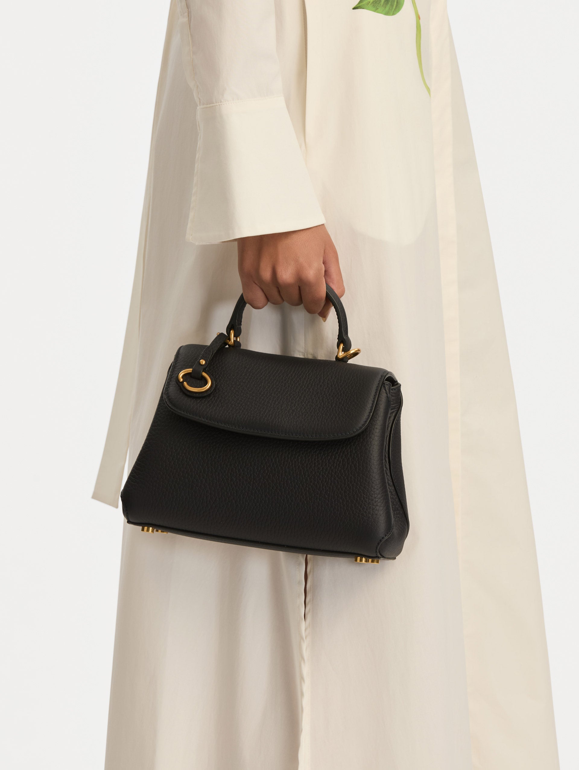 Mini Poppy in a light dark navy. The Mini Poppy is a top handle bag with a detachable shoulder strap, and it has the Oscar O logo attached around the top handle. Front View.