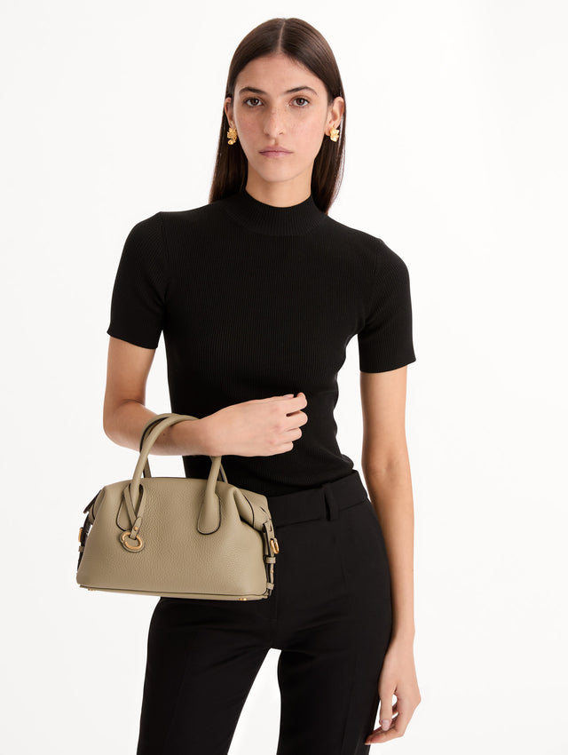 The Mini Dahlia in light green with gold hardware. Front View.