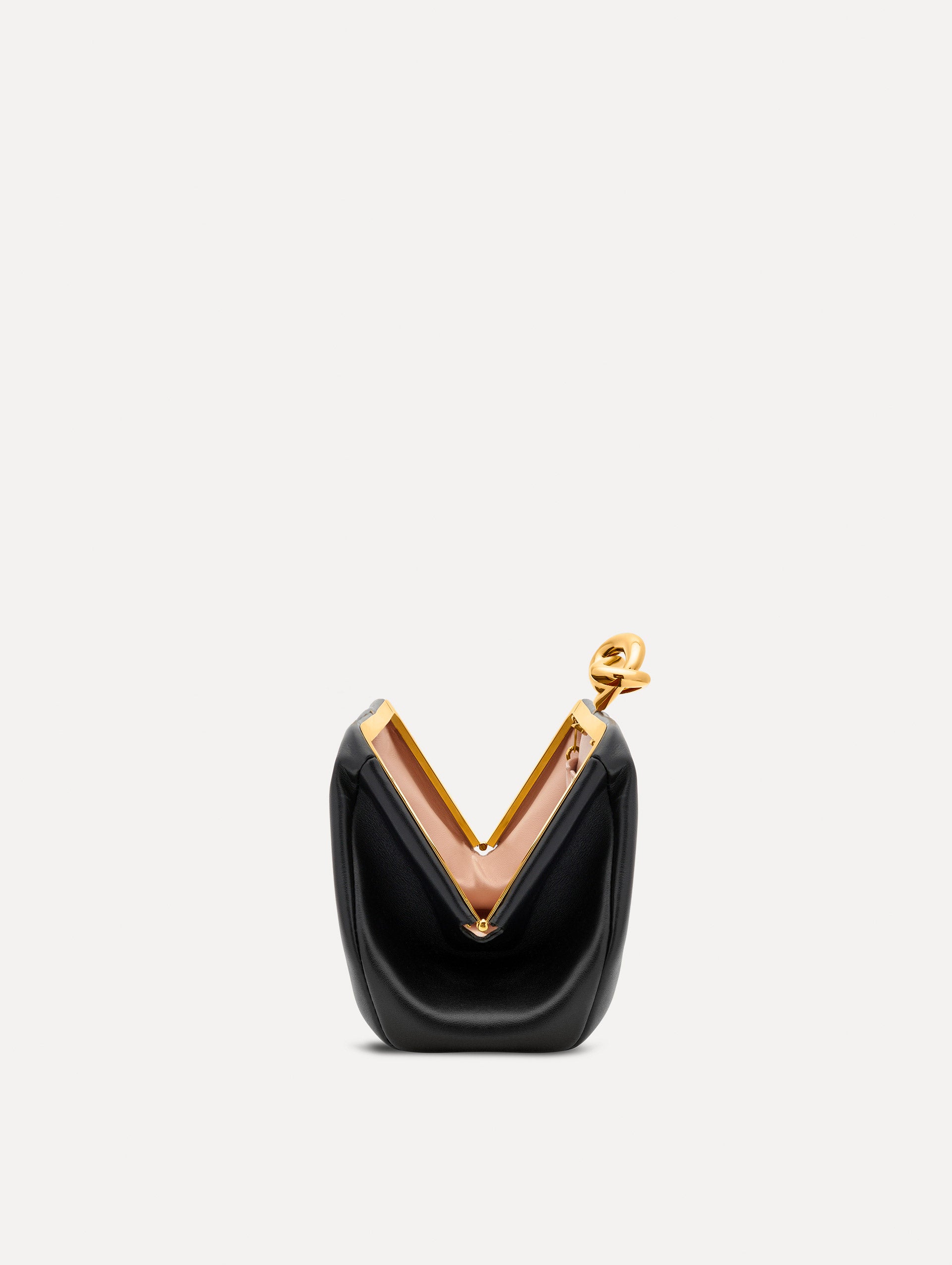 Open view of black clutch with gold 'O' emblem on the clasp. 