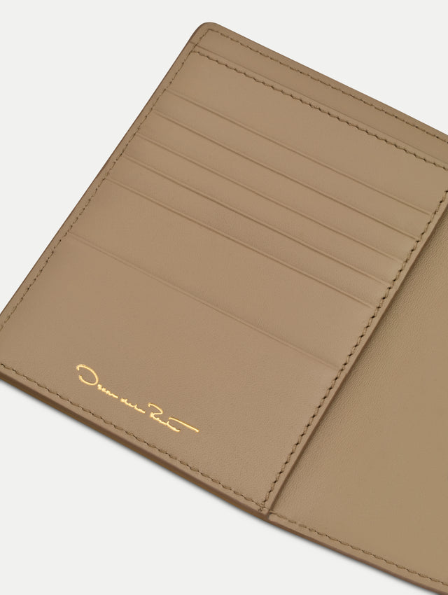 Beige Lily of the Valley–Printed Passport Cover featuring green and white floral motifs and a metal gold motif in the bottom right corner. Zoom View.