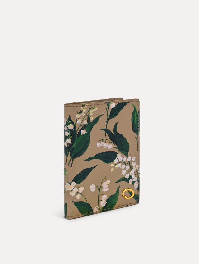Beige Lily of the Valley–Printed Passport Cover featuring green and white floral motifs and a metal gold motif in the bottom right corner. Side View.