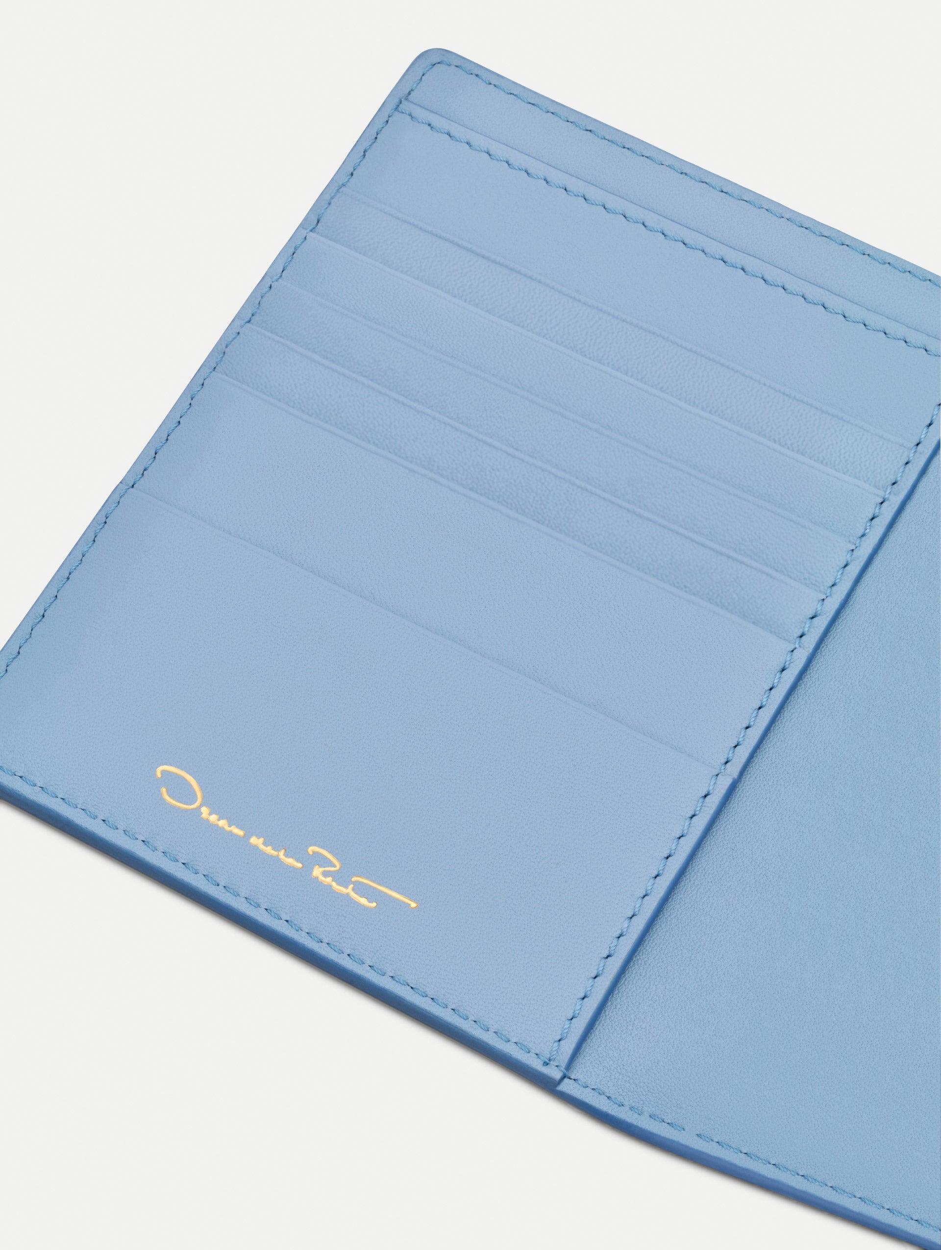 Blue Poppy-Printed Passport Cover with pink and red poppy floral motifs. Open view.