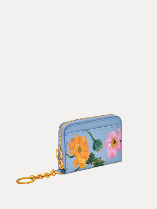 Blue Poppy Printed Zip Card case with white and red floral motifs and gold hardware. Side View.