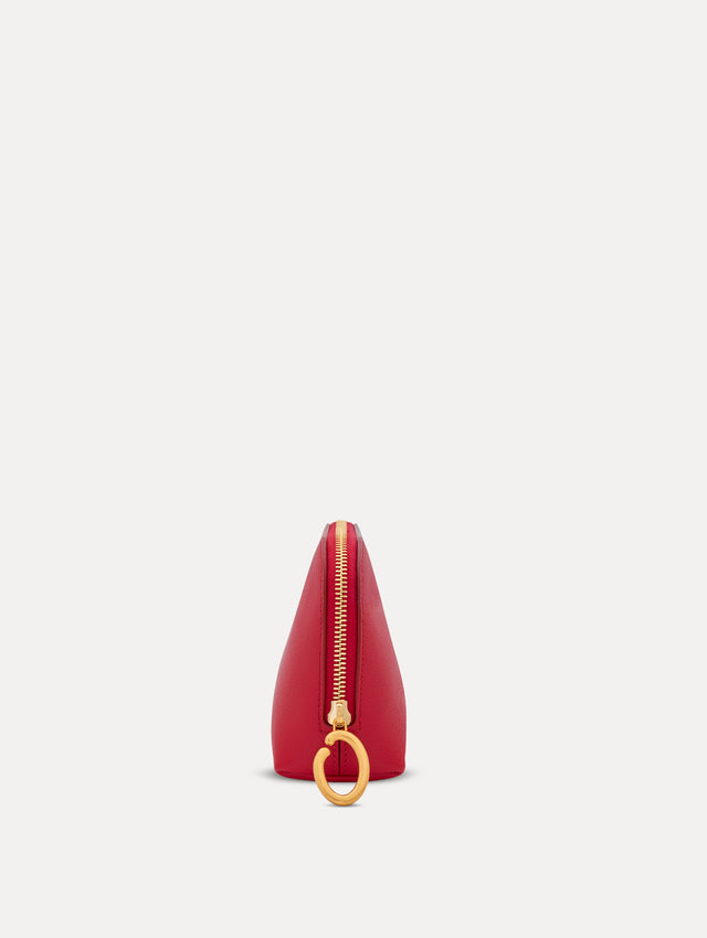 Red Small Cosmetics case in leather with gold hardware featuring an O motif zipper. Side View.