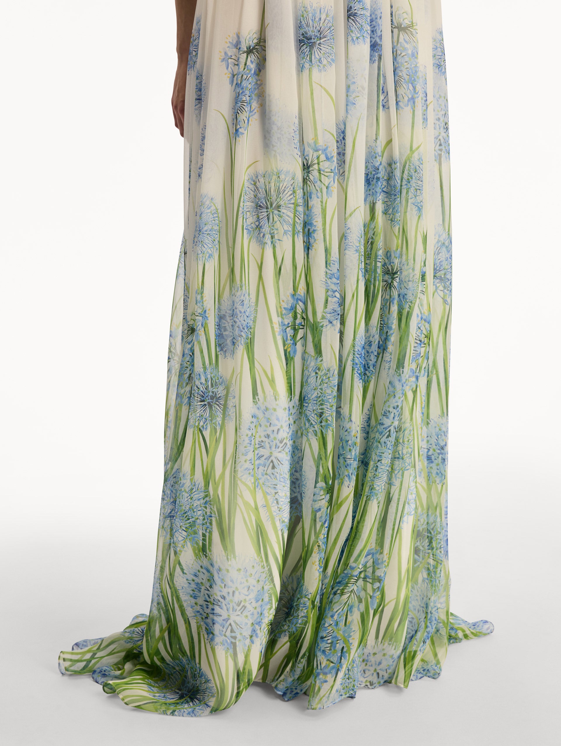 Ivory Degradé Allium Chiffon Gown featuring a ruched bodice and flowing pleated skirt with a blue allium floral gradient print. Zoom View.