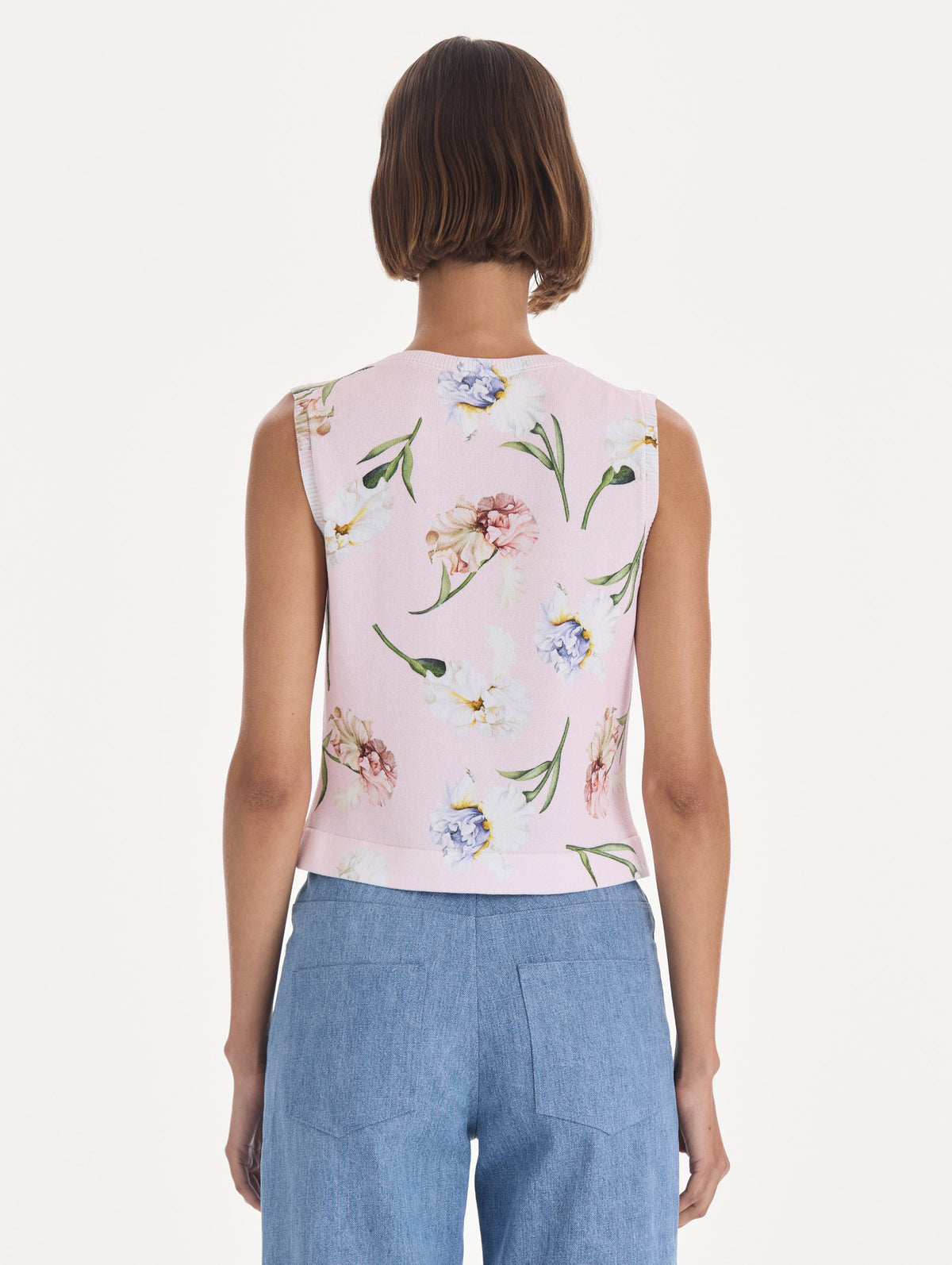 The model is wearing a printed twinset tank. Back view.