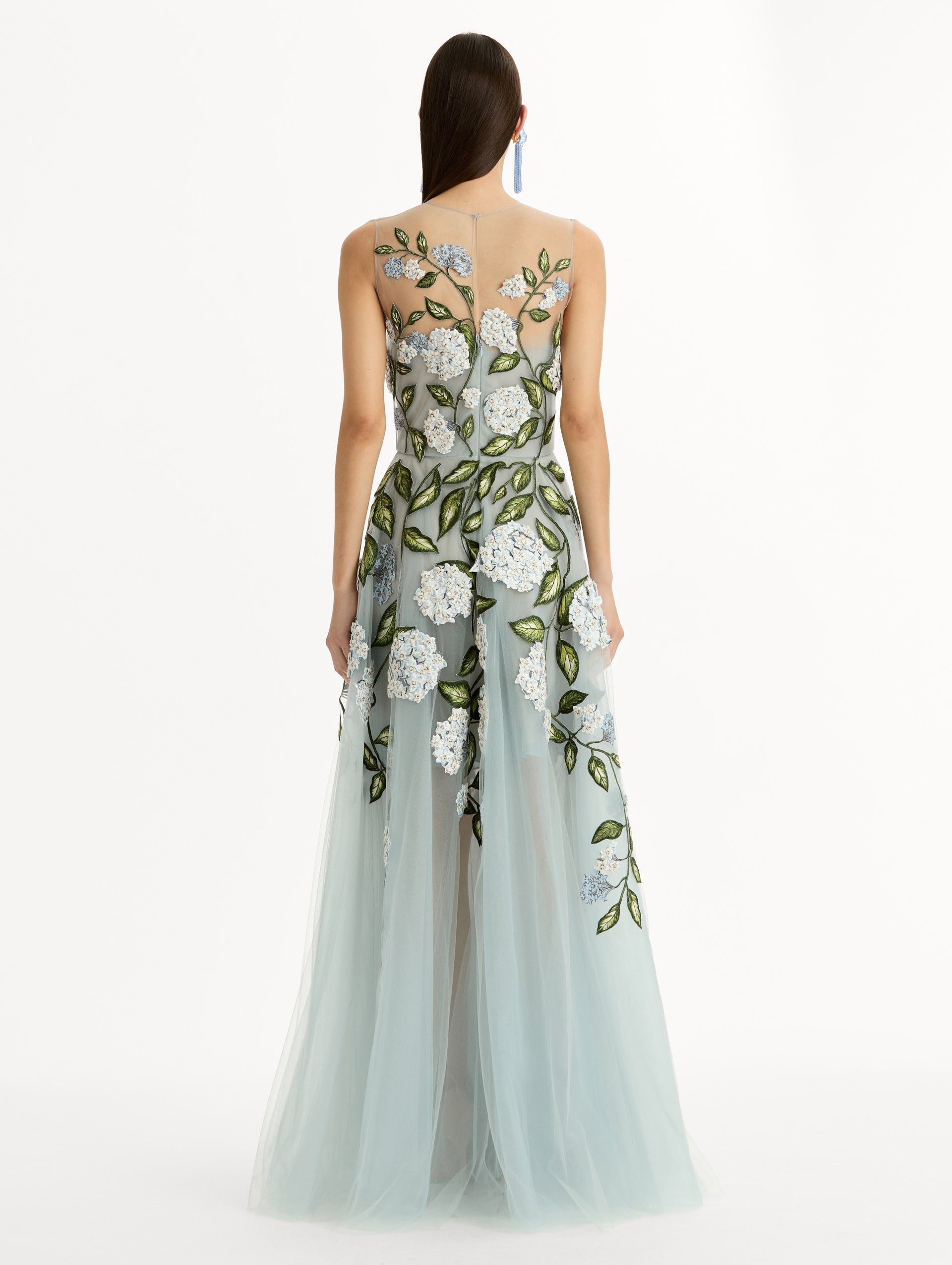 Sheer halter neck gown with porcelain flower embroidery blooming across blue illusion tulle skirt. Back View. 