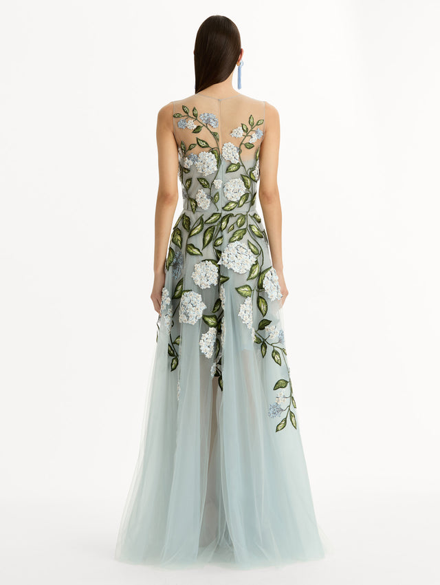 Sheer halter neck gown with porcelain flower embroidery blooming across blue illusion tulle skirt. Back View. 