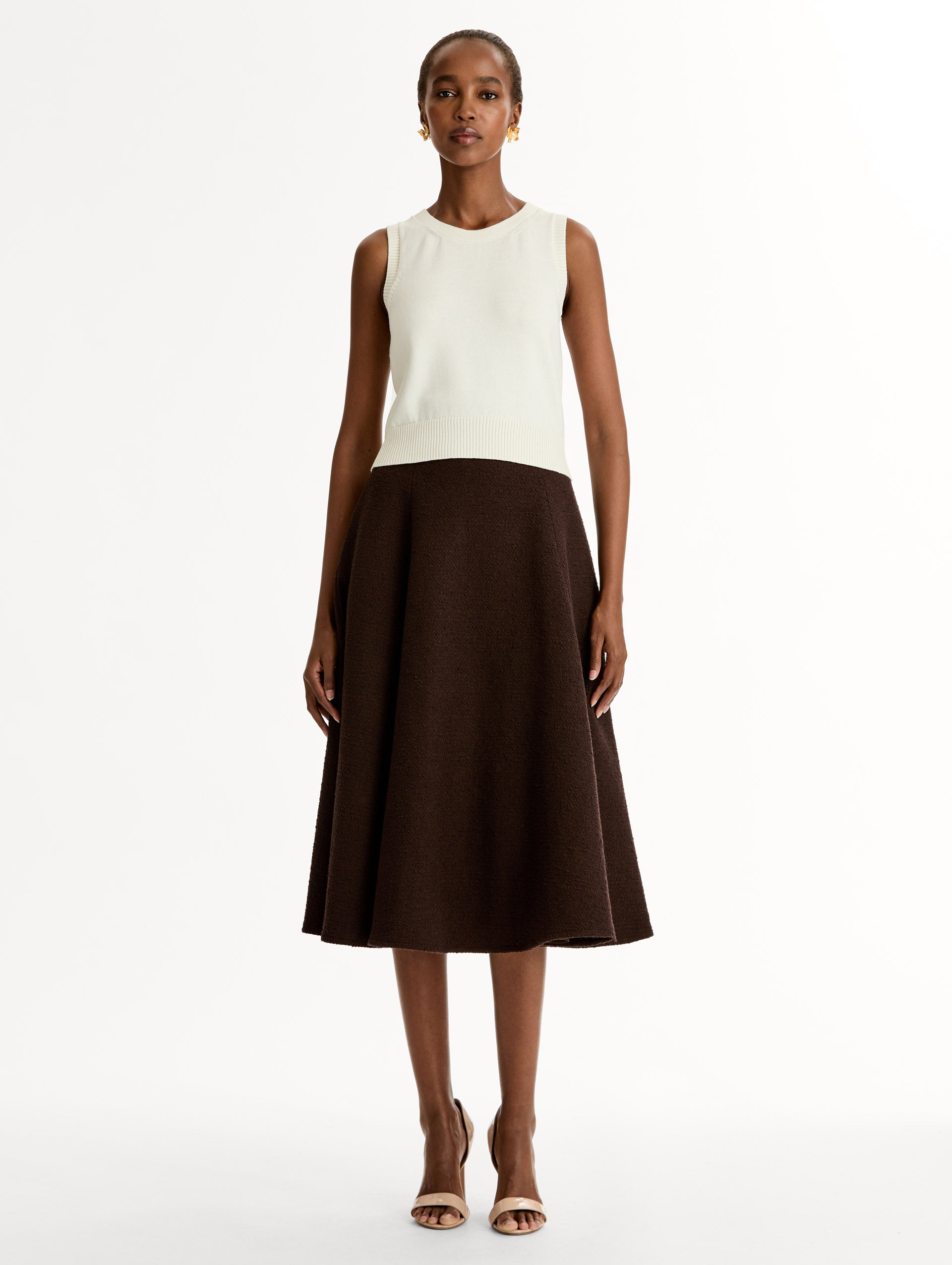 Sleeveless, halter neck, classic knit tank in soft ivory. Front View.