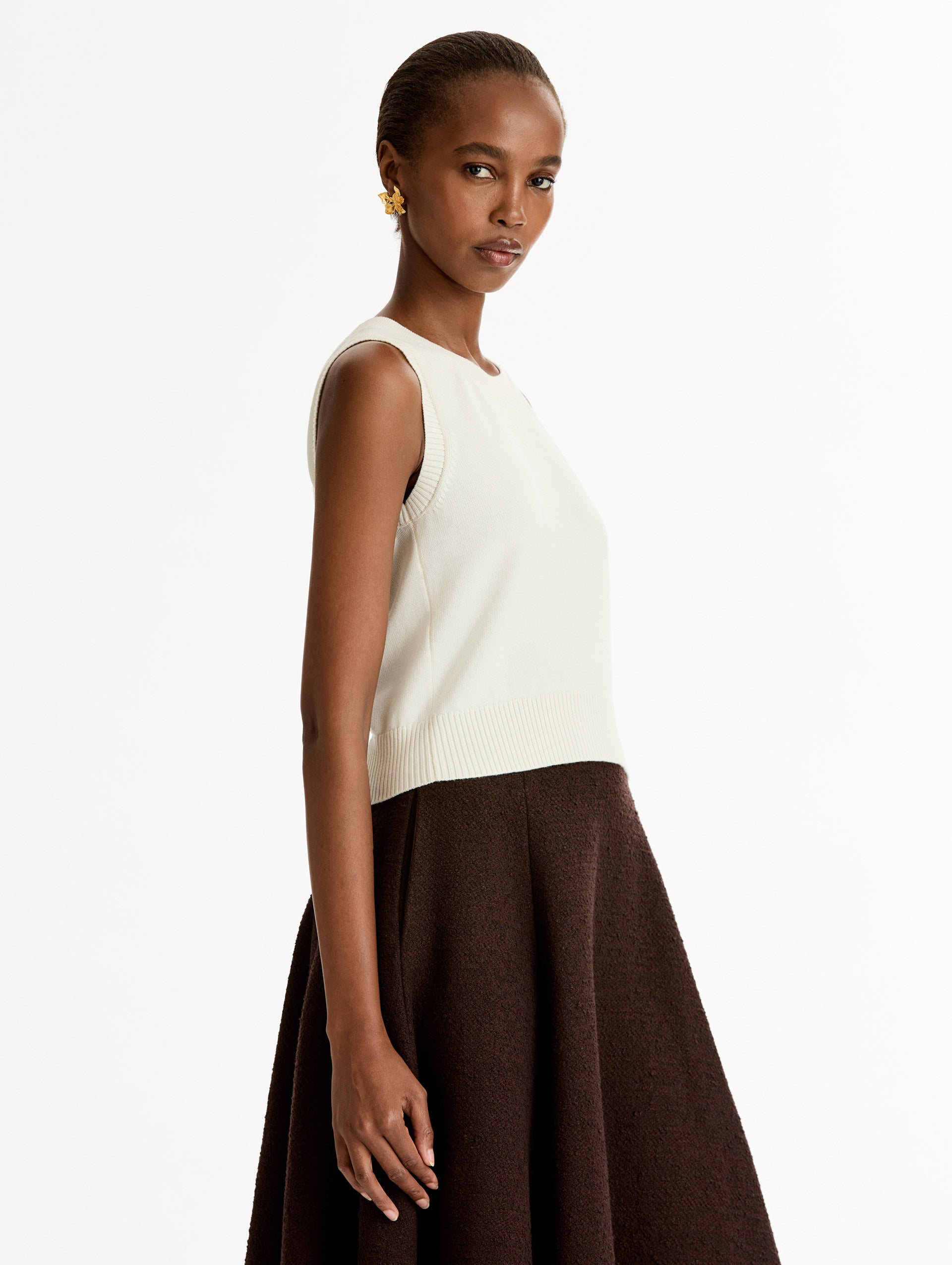 Sleeveless, halter neck, classic knit tank in soft ivory. Side View.