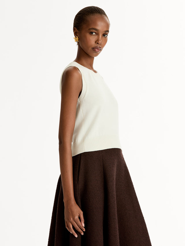 Sleeveless, halter neck, classic knit tank in soft ivory. Side View.