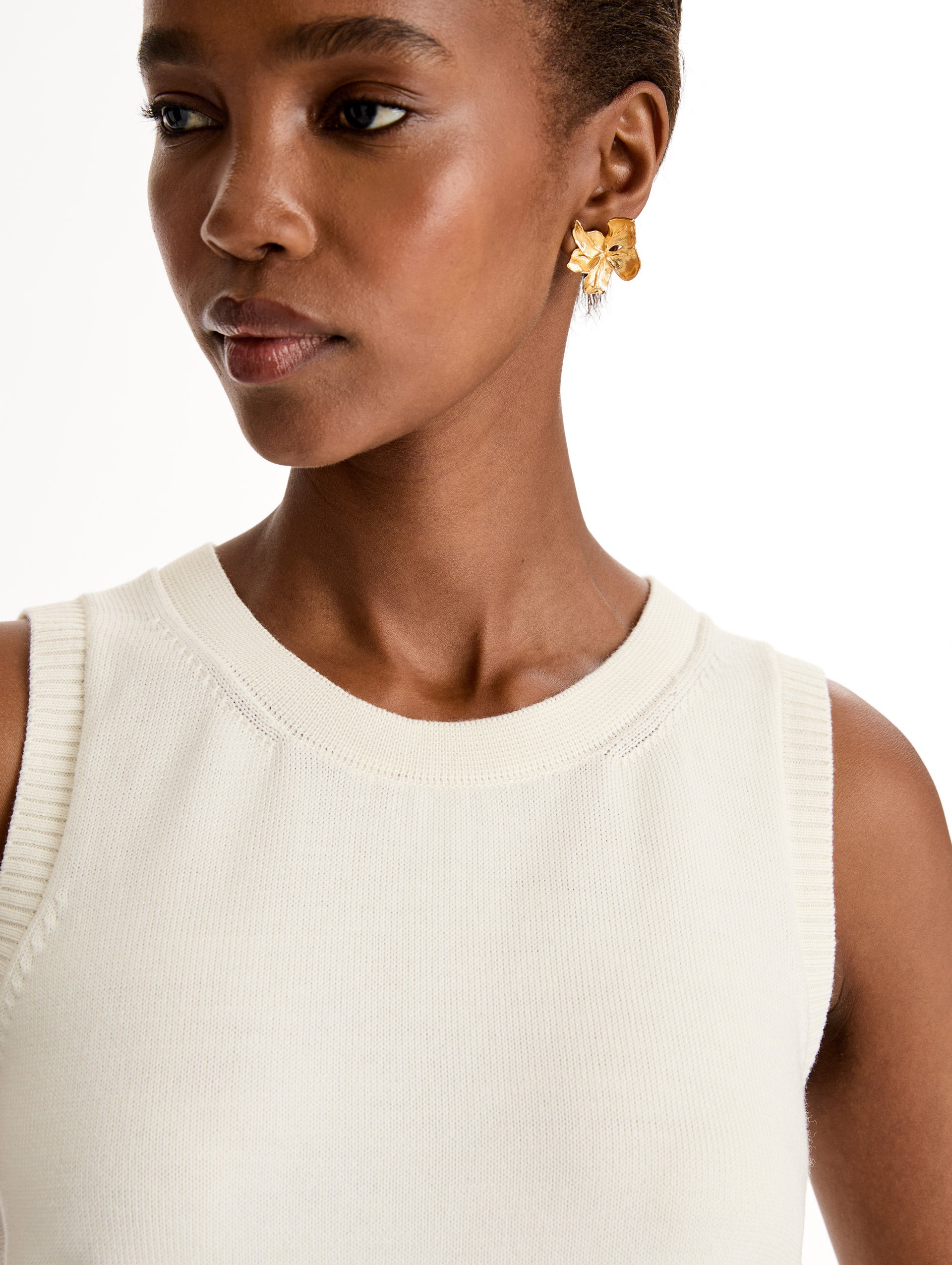 Sleeveless, halter neck, classic knit tank in soft ivory. Front View, Close Up.