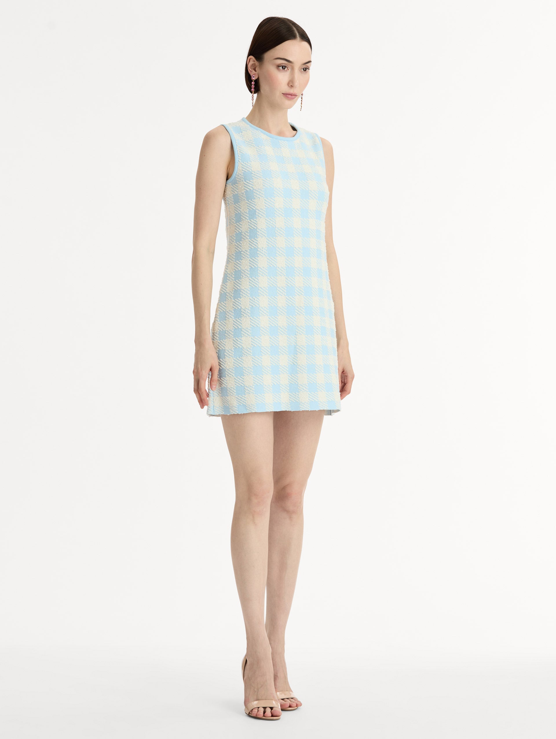 Sleeveless, texture jacquard, halter neck mini dress in Classic gingham pattern in pale blue and ivory. Side View.