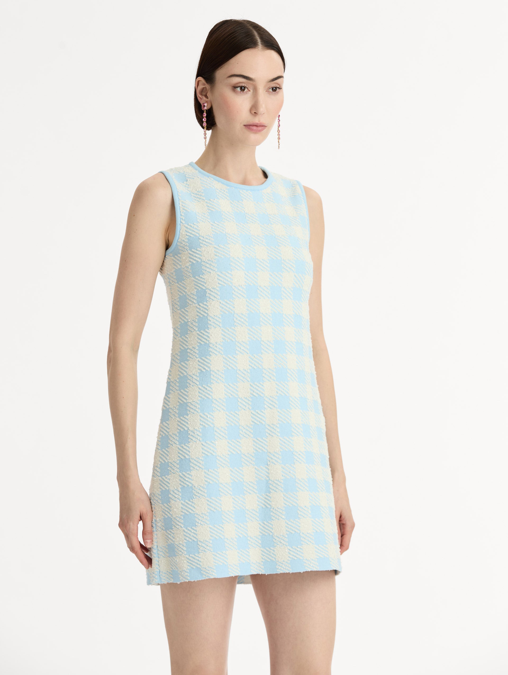 Sleeveless, texture jacquard, halter neck mini dress in Classic gingham pattern in pale blue and ivory. Side View.
