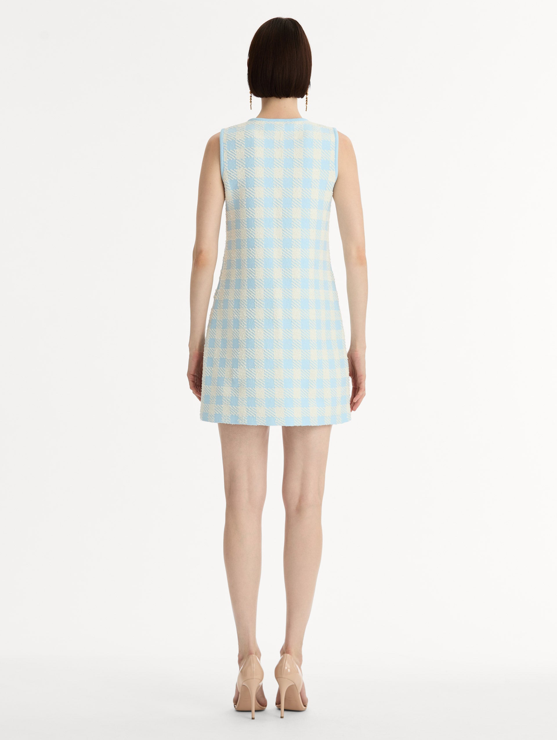 Sleeveless, texture jacquard, halter neck mini dress in Classic gingham pattern in pale blue and ivory. Back View.