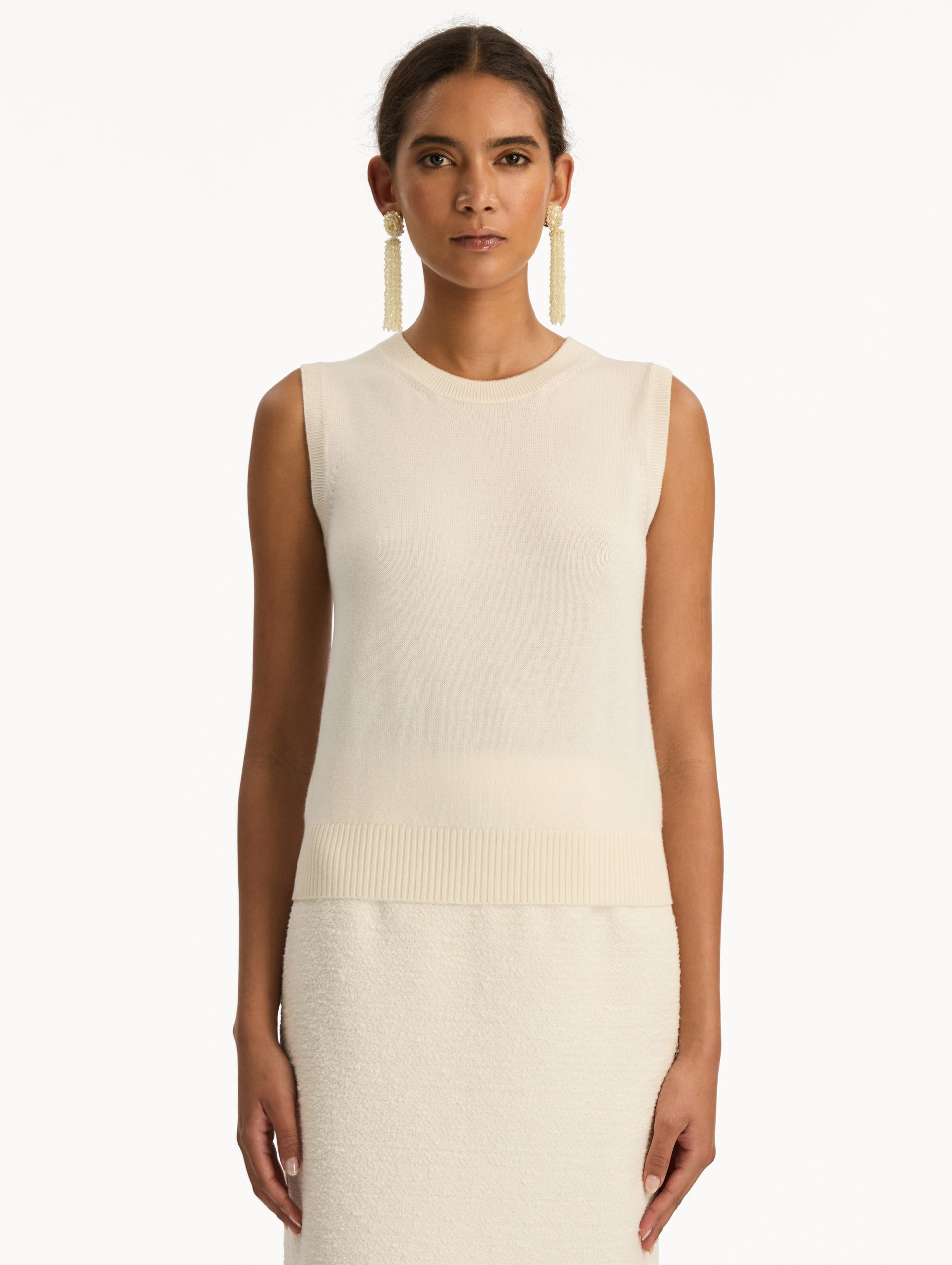 Ivory Virgin Wool Tank featuring a crew neckline and ribbed hem. Front View.