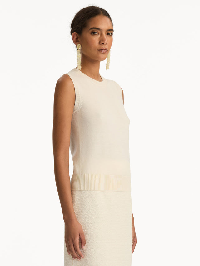 Ivory Virgin Wool Tank featuring a crew neckline and ribbed hem. Side View.