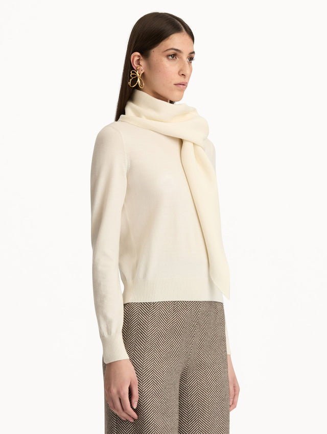 Ivory Virgin Wool Pullover with Scarf featuring a draped attached scarf neckline and long sleeves. Side View.