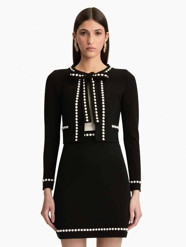 Black and White Bubble Trim Cardigan featuring white beaded trim, long sleeves, and a tie-neck collar. Front View.