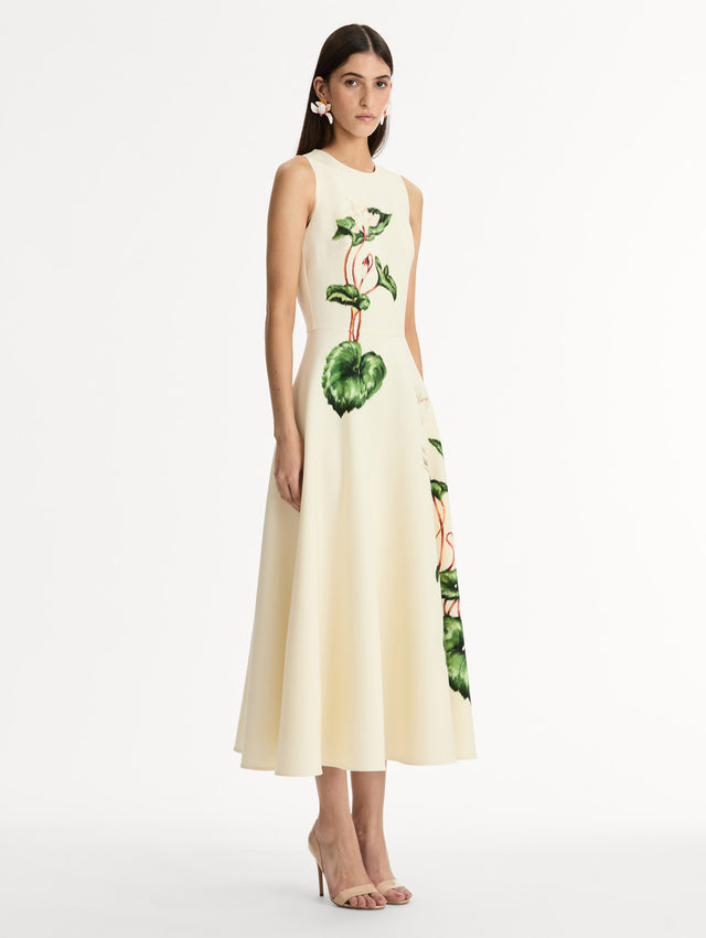 Halter Neck, Sleeveless midi dress with fitted bodice and flared midi skirt. Chiné Cyclamen motif on soft ivory background with blurred edges. Side View.