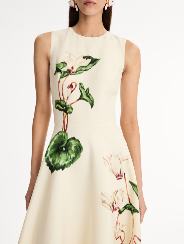 Halter Neck, Sleeveless midi dress with fitted bodice and flared midi skirt. Chiné Cyclamen motif on soft ivory background with blurred edges. Front View, Close Up.