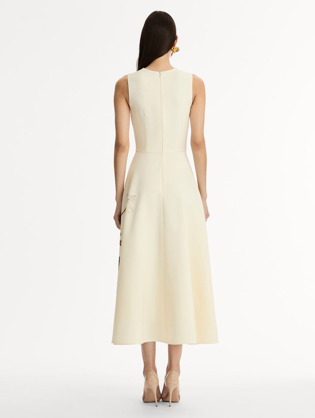 Halter Neck, Sleeveless midi dress with fitted bodice and flared midi skirt. Chiné Cyclamen motif on soft ivory background with blurred edges. Back View.