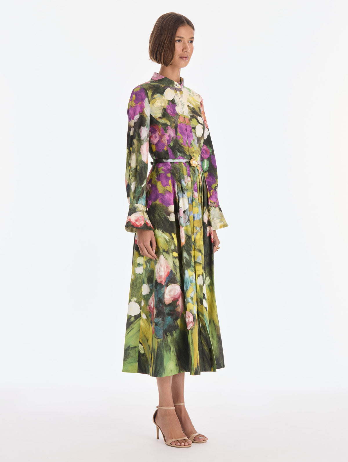 The model is wearing a long sleeve abstract garden poplin sateen dress. Side view.