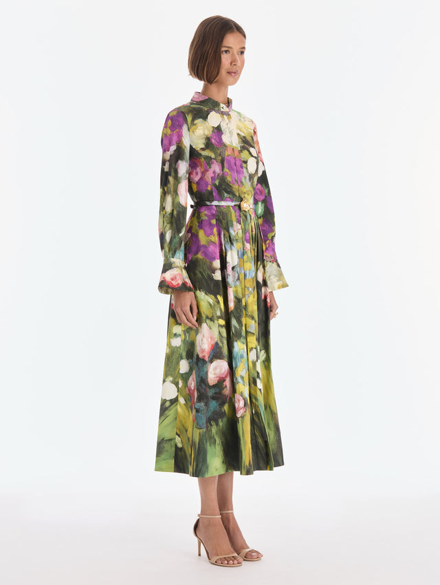 The model is wearing a long sleeve abstract garden poplin sateen dress. Side view.