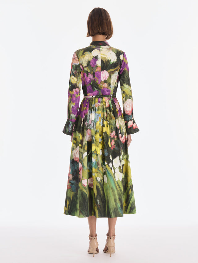 The model is wearing a long sleeve abstract garden poplin sateen dress. Back view.