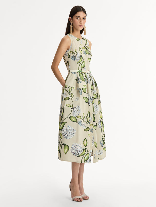 Porcelain Flower Cotton Poplin Dress This cotton poplin dress. Clean, sculpted lines. Relaxed, mid-length silhouette. with cinching matching self-belt at the waist. Side View.