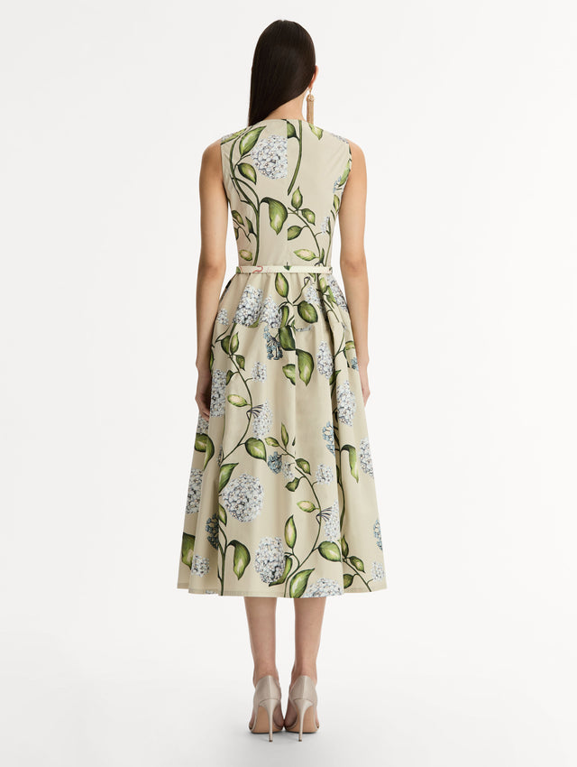 Porcelain Flower Cotton Poplin Dress This cotton poplin dress. Clean, sculpted lines. Relaxed, mid-length silhouette. with cinching matching self-belt at the waist. Back View.