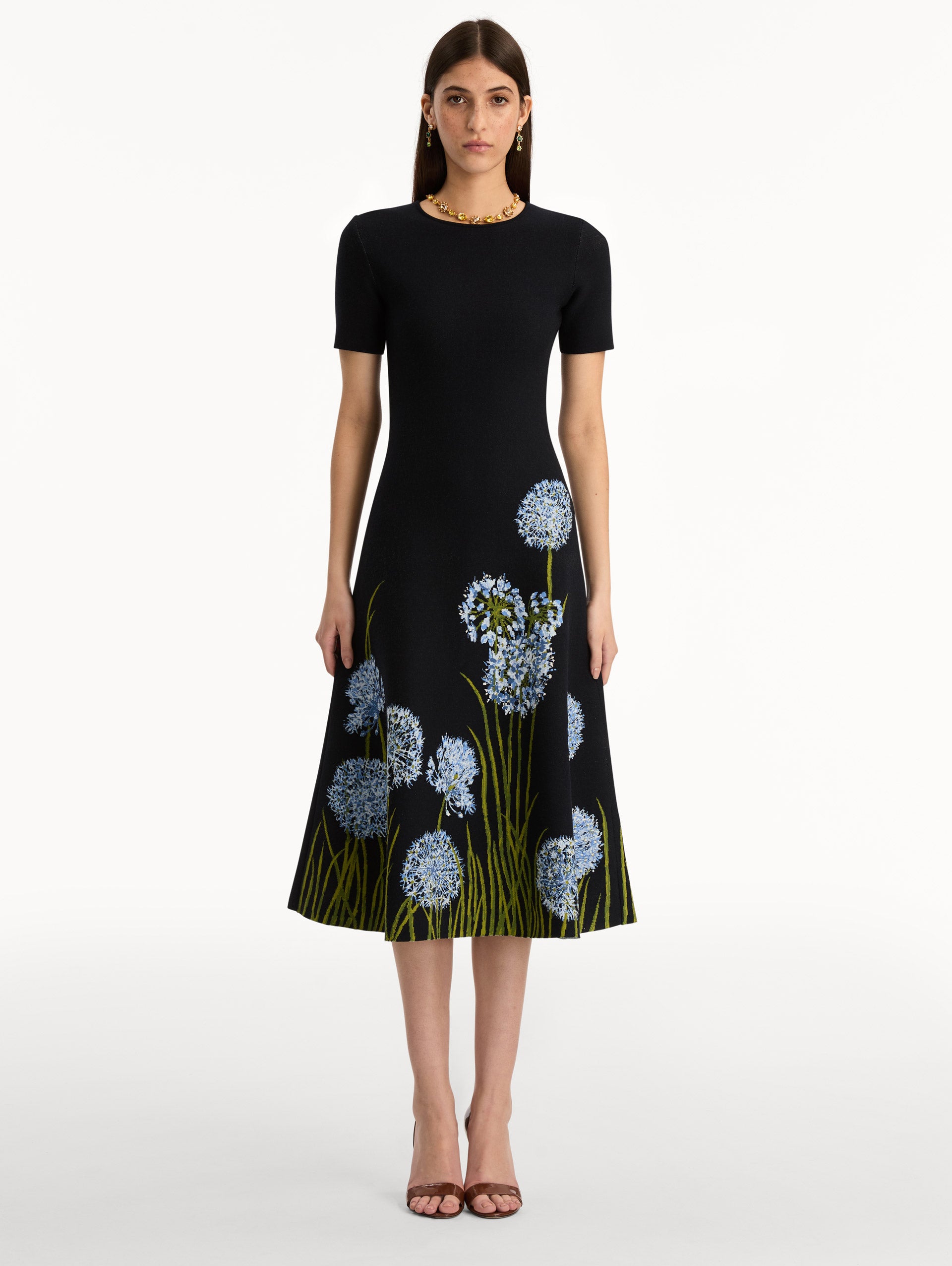 Navy Allium Jacquard Knit Dress featuring blue floral embroidery with green stem detailing along the skirt. Front View.