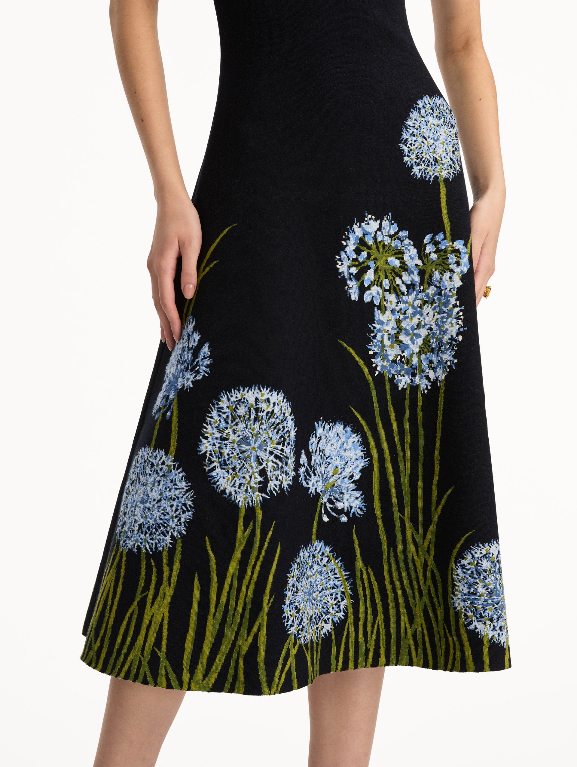 Navy Allium Jacquard Knit Dress featuring blue floral embroidery with green stem detailing along the skirt. Zoom View.