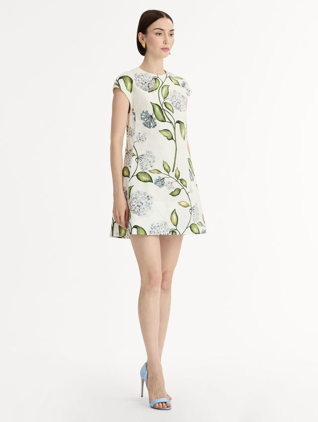 Porcelain Flower Cotton Poplin A-Line Mini Dress. Short Sleeves. Blue and Green Floral Motif. Side View.