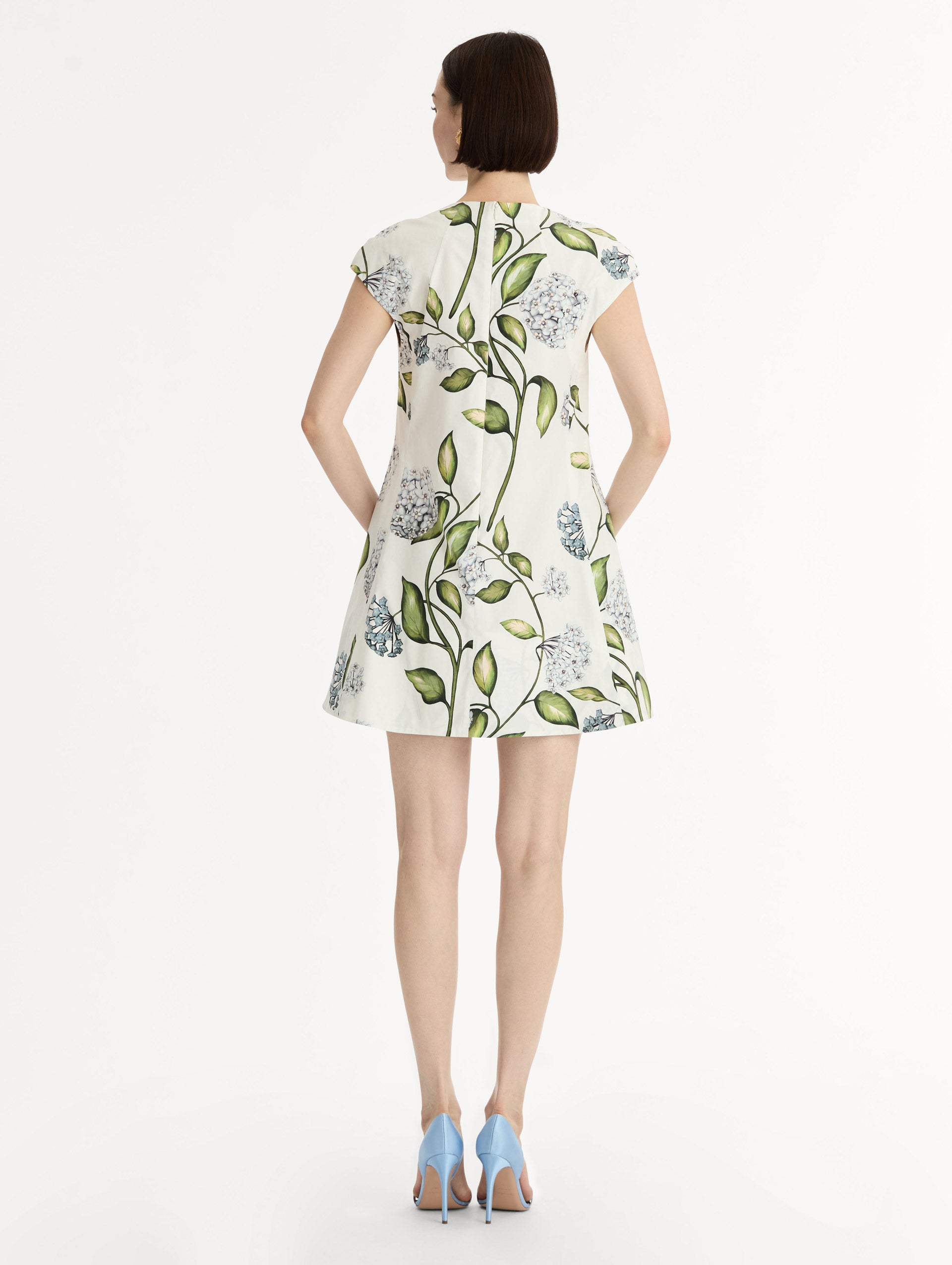 Porcelain Flower Cotton Poplin A-Line Mini Dress. Short Sleeves. Blue and Green Floral Motif. Back View.