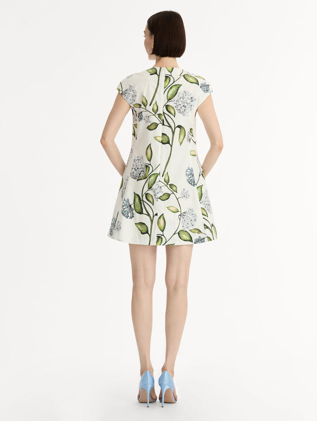 Porcelain Flower Cotton Poplin A-Line Mini Dress. Short Sleeves. Blue and Green Floral Motif. Back View.