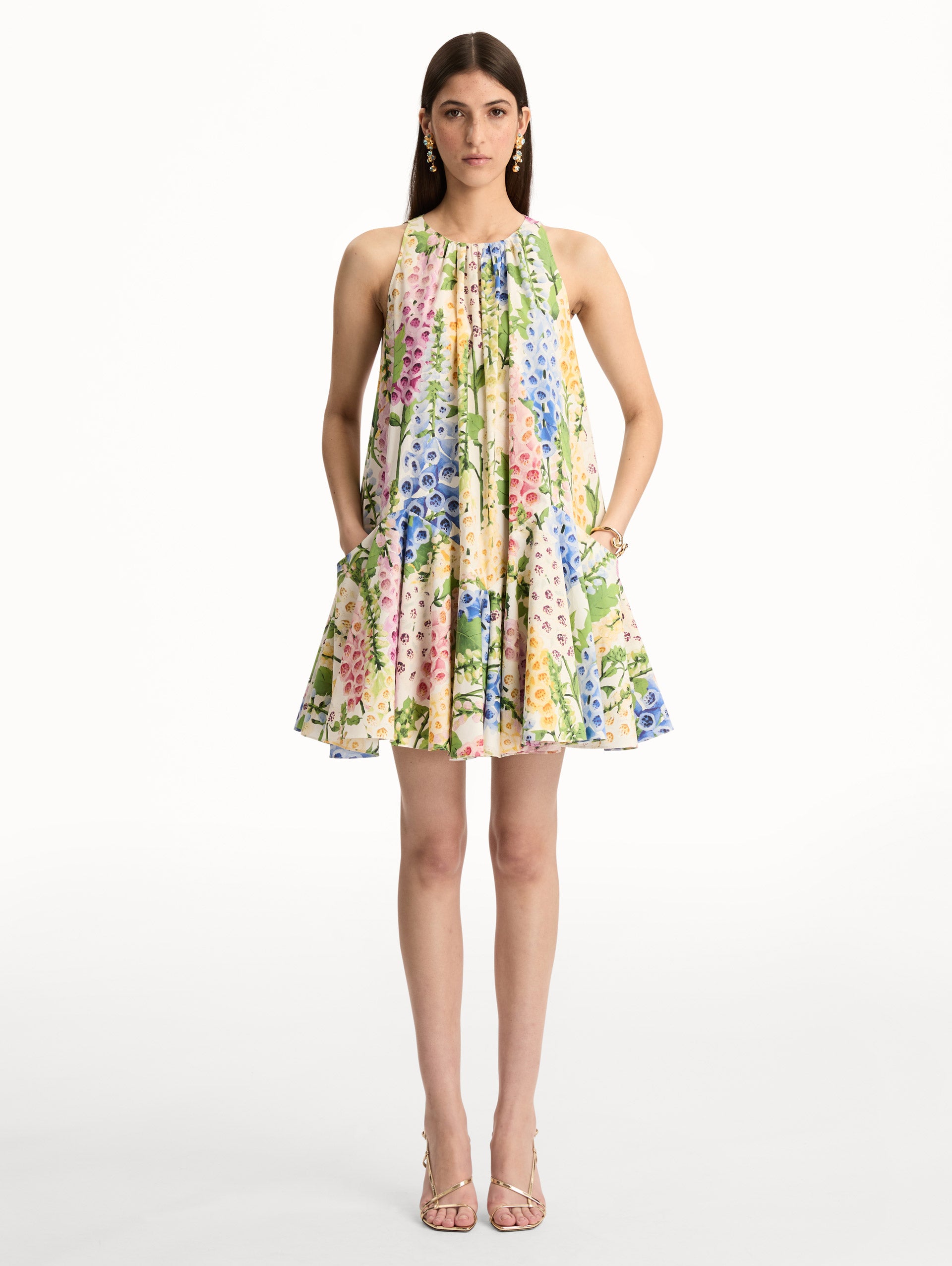 White and Floral Foxglove Cotton Poplin Trapeze Dress with a flowing pleated silhouette and round neckline. Front View.