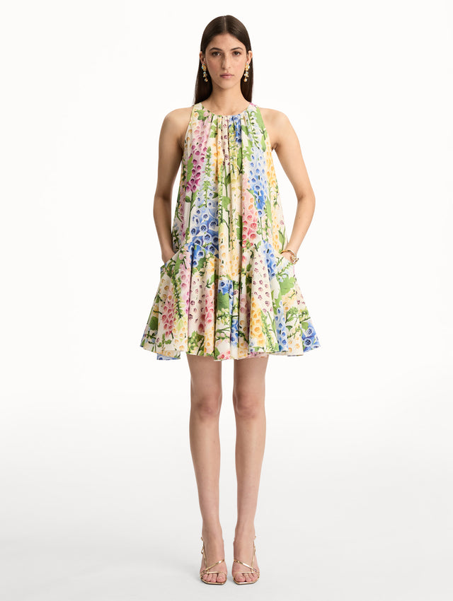 White and Floral Foxglove Cotton Poplin Trapeze Dress with a flowing pleated silhouette and round neckline. Front View.