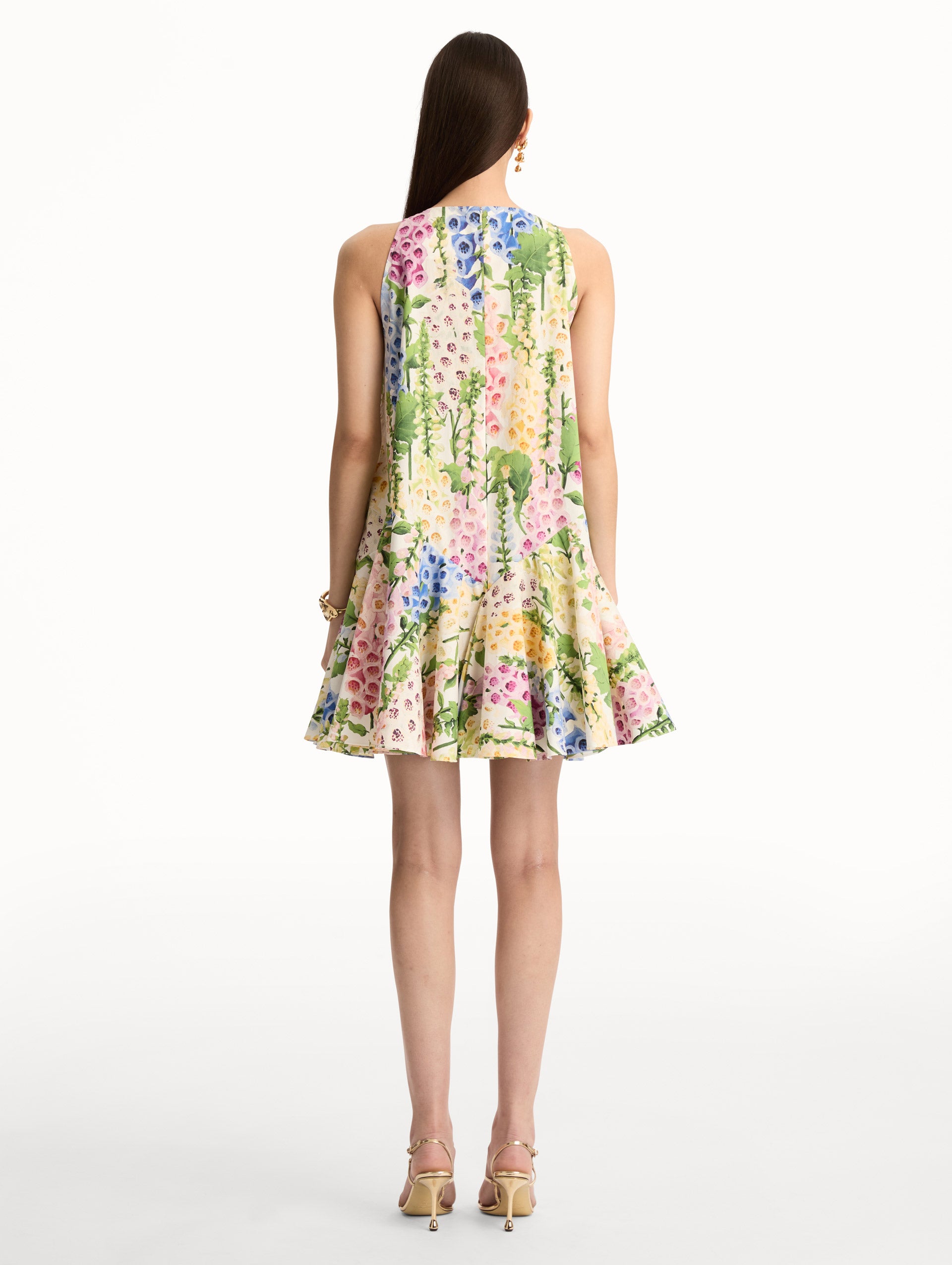 White and Floral Foxglove Cotton Poplin Trapeze Dress with a flowing pleated silhouette and round neckline. Back View.
